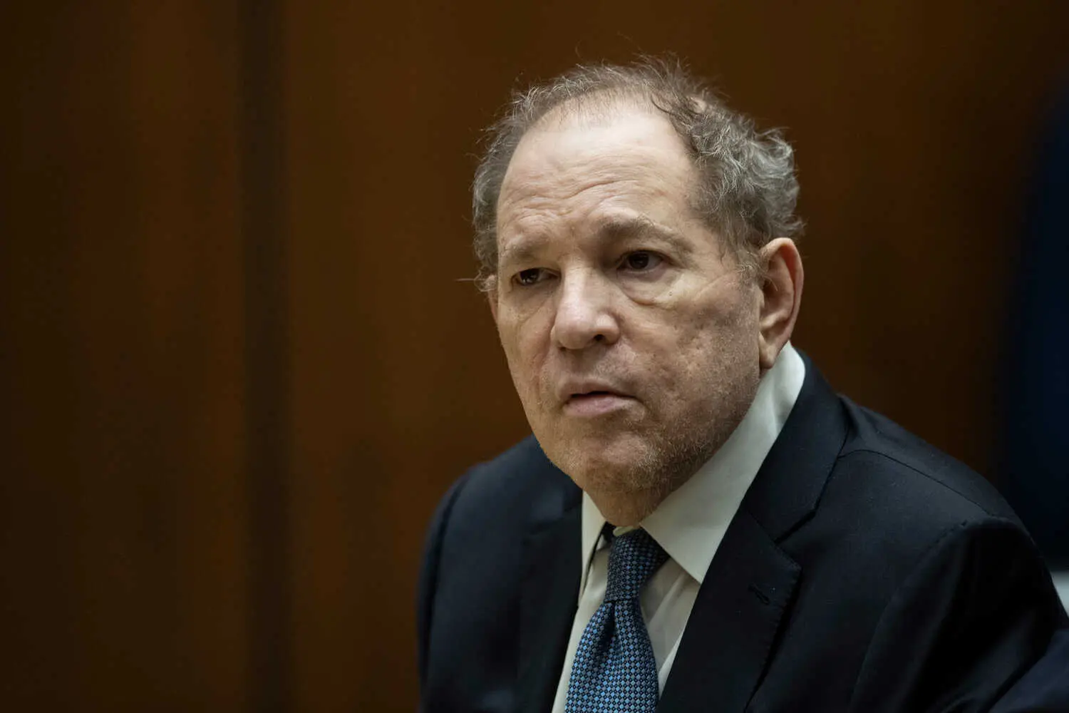 Harvey Weinstein in court in a dark suit.